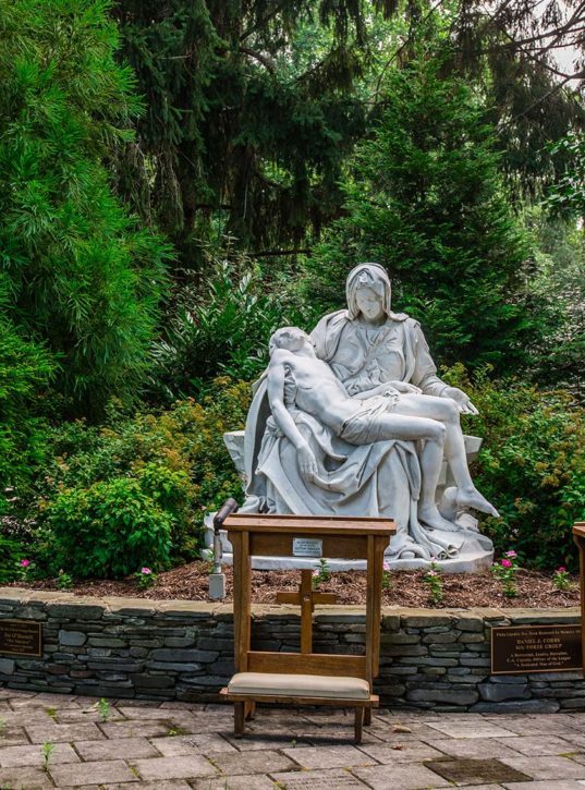 The Piet&agrave; statue with a kneeler